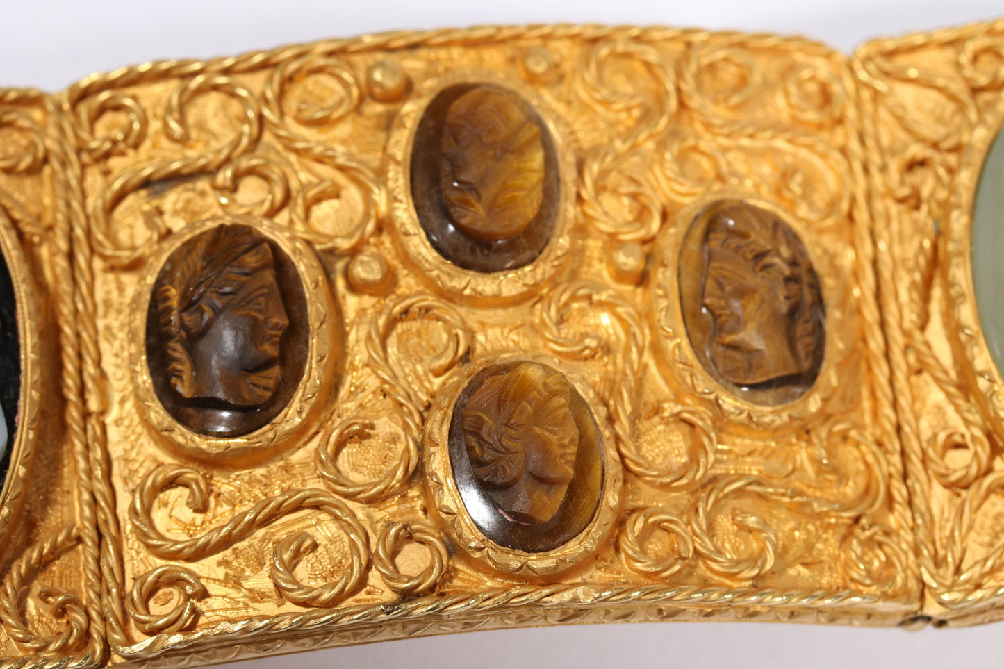Antique 18K yellow gold Victorian panel bracelet with 19 intricate left and right facing cameos carved from natural stone including tigers eye, onyx, coral, shell, and more. 8 1/4"L x 1 1/8"W