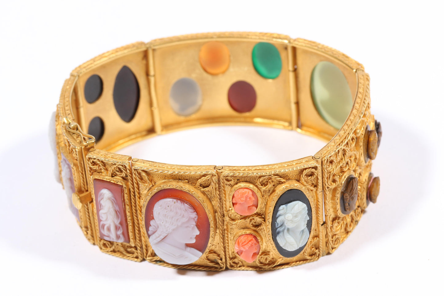 Antique 18K yellow gold Victorian panel bracelet with 19 intricate left and right facing cameos carved from natural stone including tigers eye, onyx, coral, shell, and more. 8 1/4"L x 1 1/8"W