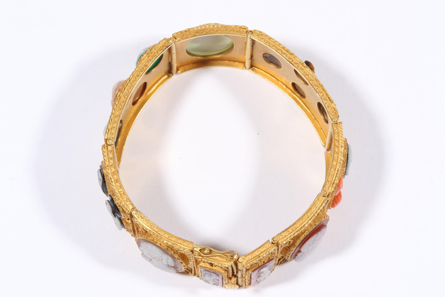 Antique 18K yellow gold Victorian panel bracelet with 19 intricate left and right facing cameos carved from natural stone including tigers eye, onyx, coral, shell, and more. 8 1/4"L x 1 1/8"W
