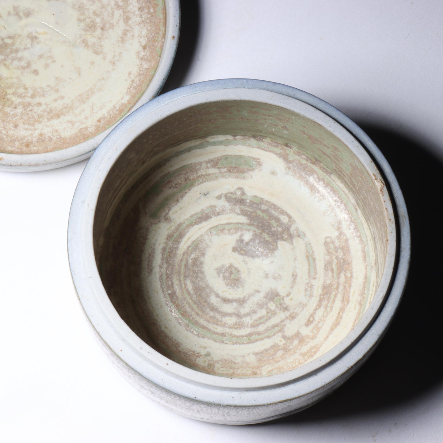 Laura Andreson, California (1902 - 1999), American studio pottery round lidded box, 1976, porcelain with complex white and gray brushed over layered sage green over blue matte glaze, 2 1/4"H x 3 1/4"Diam.