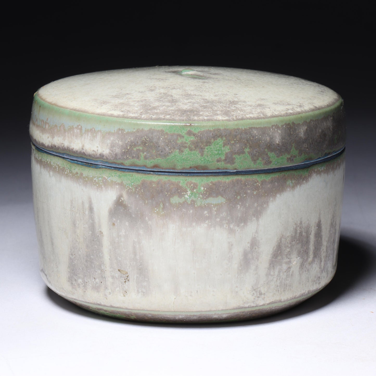 Laura Andreson, California (1902 - 1999), American studio pottery round lidded box, 1976, porcelain with complex white and gray brushed over layered sage green over blue matte glaze, 2 1/4"H x 3 1/4"Diam.