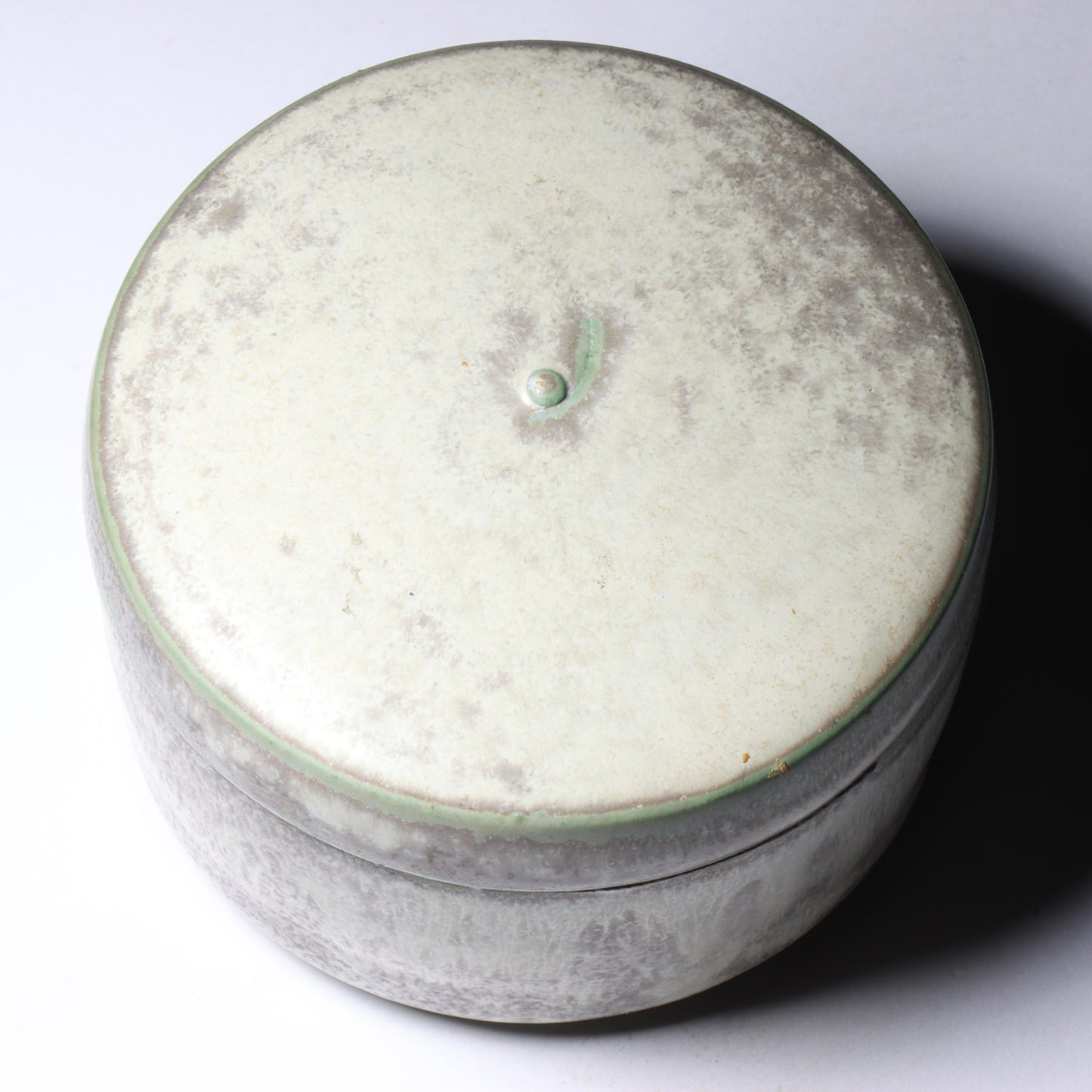 Laura Andreson, California (1902 - 1999), American studio pottery round lidded box, 1976, porcelain with complex white and gray brushed over layered sage green over blue matte glaze, 2 1/4"H x 3 1/4"Diam.