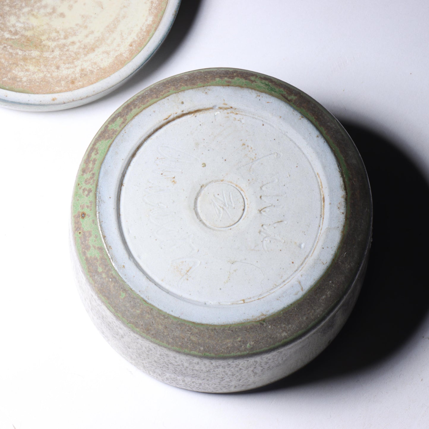 Laura Andreson, California (1902 - 1999), American studio pottery round lidded box, 1976, porcelain with complex white and gray brushed over layered sage green over blue matte glaze, 2 1/4"H x 3 1/4"Diam.