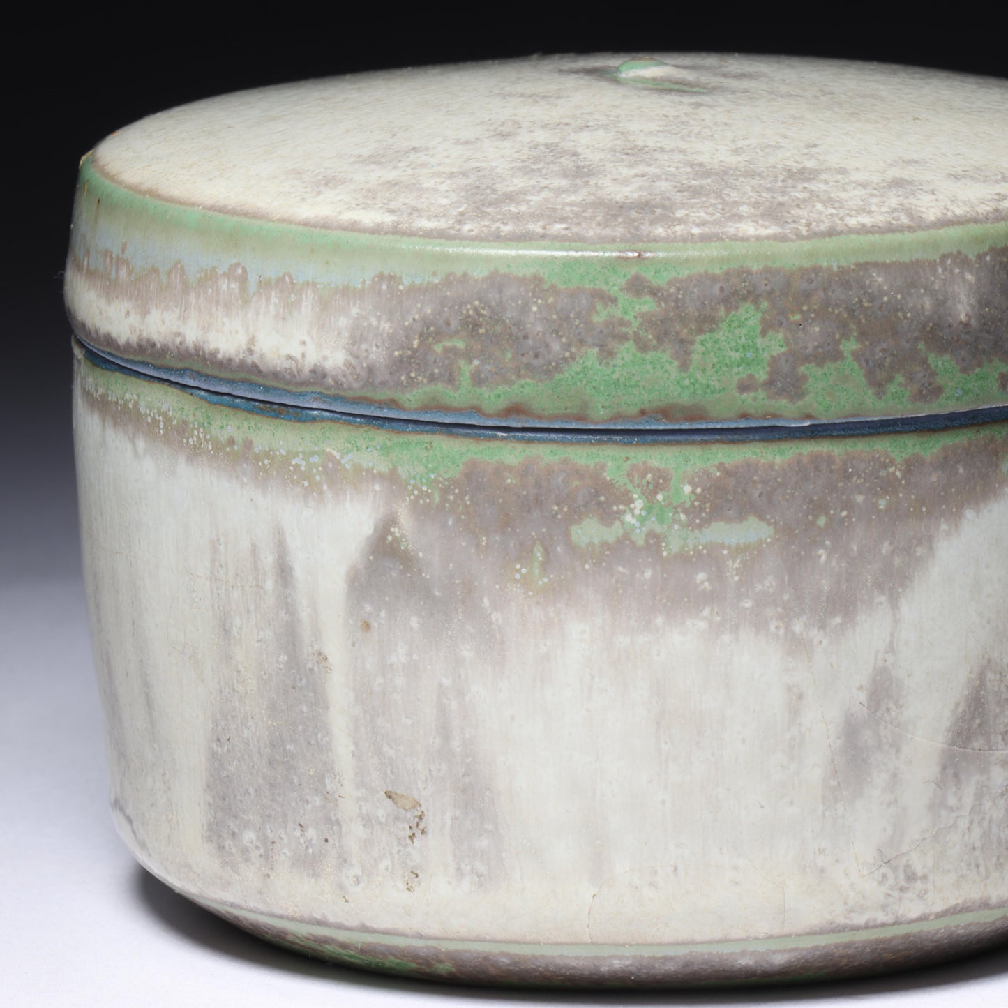 Laura Andreson, California (1902 - 1999), American studio pottery round lidded box, 1976, porcelain with complex white and gray brushed over layered sage green over blue matte glaze, 2 1/4"H x 3 1/4"Diam.