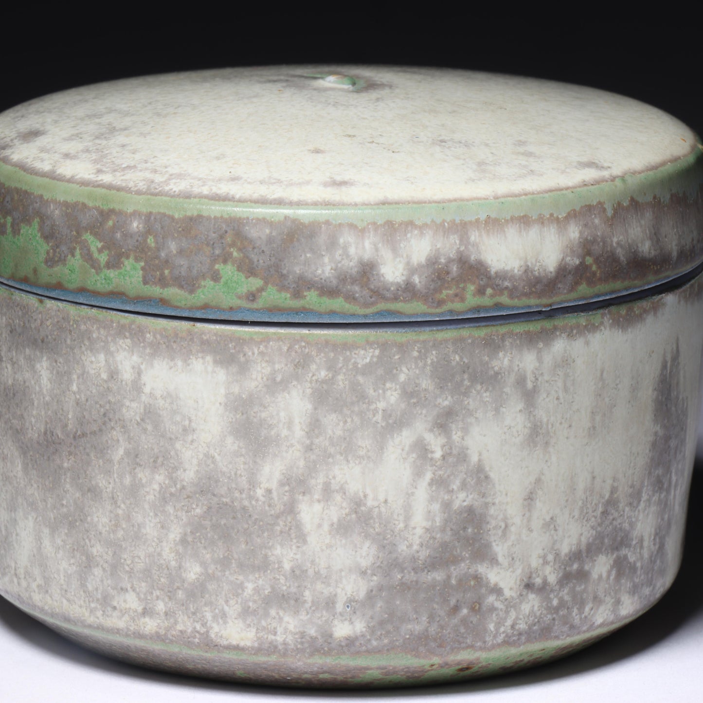 Laura Andreson, California (1902 - 1999), American studio pottery round lidded box, 1976, porcelain with complex white and gray brushed over layered sage green over blue matte glaze, 2 1/4"H x 3 1/4"Diam.