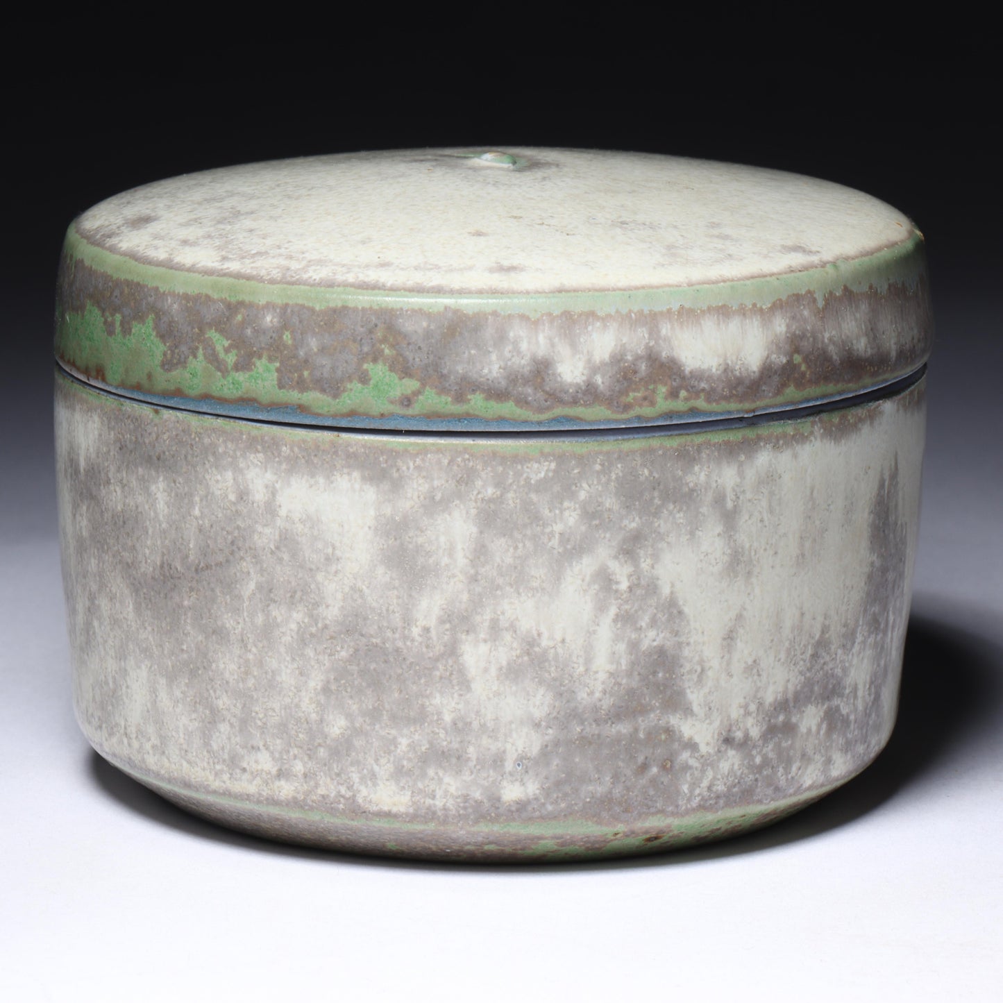 Laura Andreson, California (1902 - 1999), American studio pottery round lidded box, 1976, porcelain with complex white and gray brushed over layered sage green over blue matte glaze, 2 1/4"H x 3 1/4"Diam.